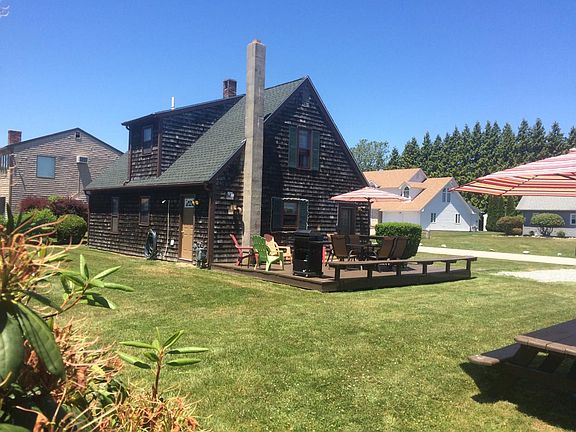 Cape style home with generous side deck and yard