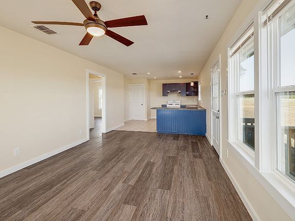 Living space looking into kitchen and bedroom hallway.
