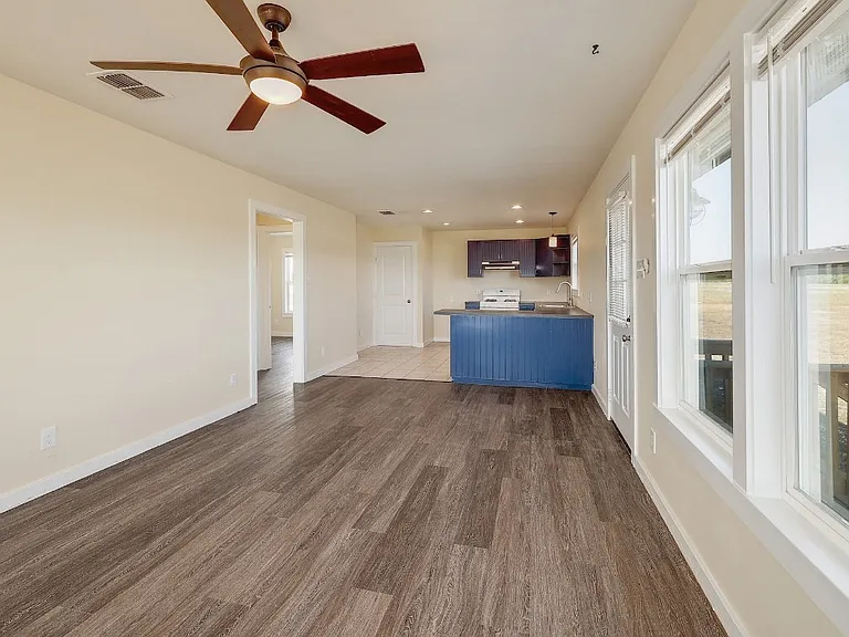 Living space looking into kitchen and bedroom hallway.