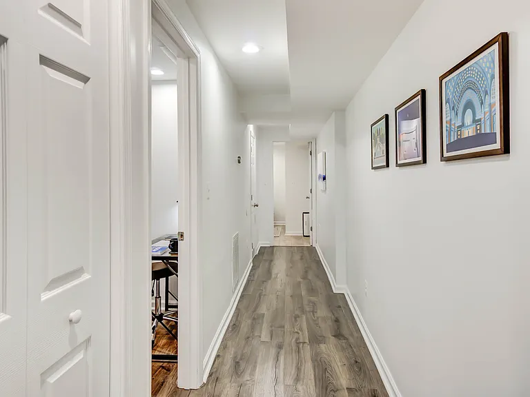 As you enter the wide hallway leading to the bedrooms and bathroom, you'll find a conveniently tucked-away closet on the left housing the in-unit stacked washer and dryer for easy everyday access.