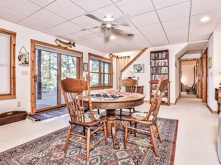 Lower level Family Room from another angle with view down the hallway that includes large full bathroom, laundry room, and bedroom with two Queen beds.