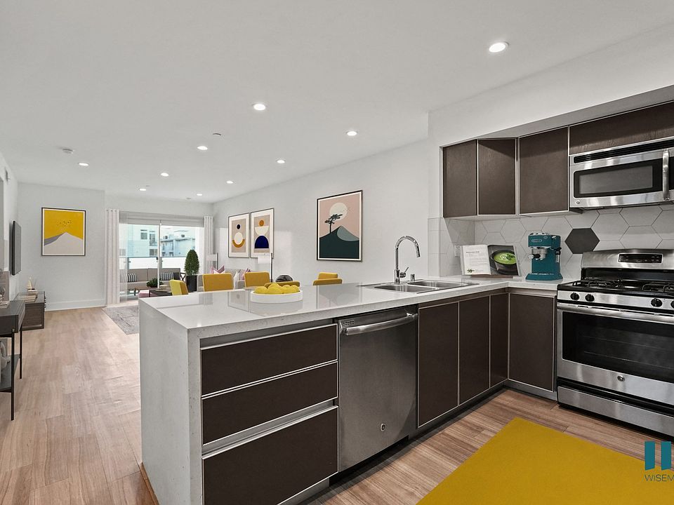 Open-Concept Kitchen, Dining, and Living Room with Patio