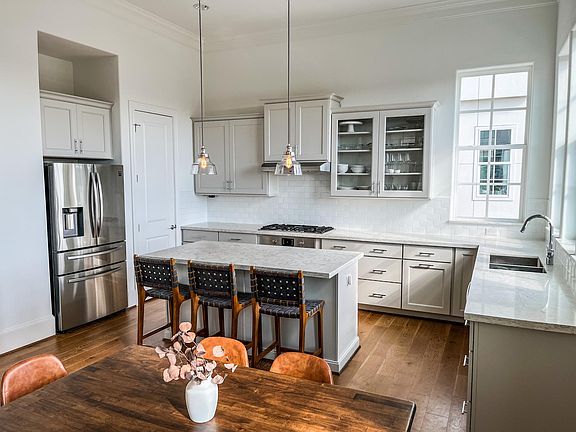 Open kitchen and dining layout. The space easily allows for any dining table size.