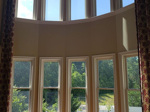 Family Living Room Double Ceiling, Wall of Windows overlooking backyard and extended natural view!