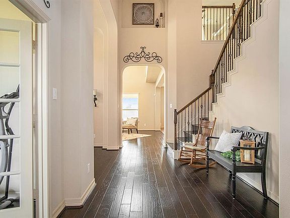 Open the door to a light and bright home with high ceilings and gorgeous wood flooring that flows through the study, entry, formal dining, family room and both downstairs bedrooms!!!