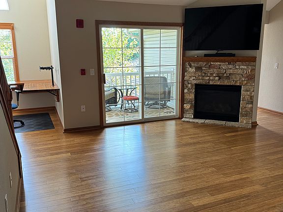 Living room and fireplace with included 65" TCL TV and Bose sound bar