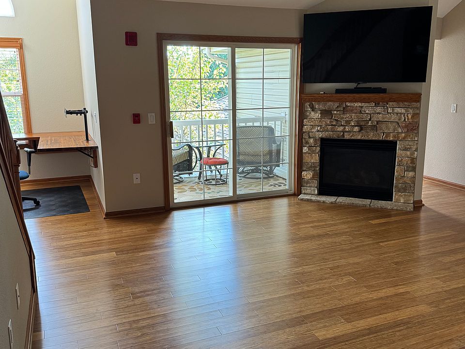 Living room and fireplace with included 65" TCL TV and Bose sound bar