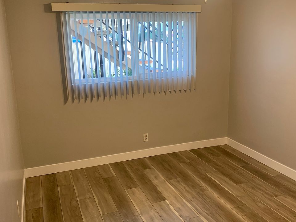 Bedroom with new vinyl plank flooring and paint