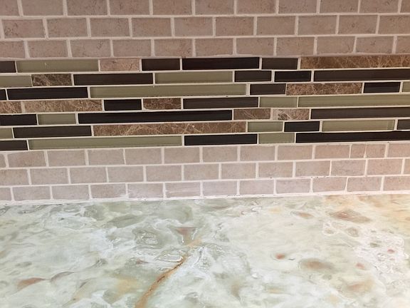 Countertop and tile backsplash in kitchen