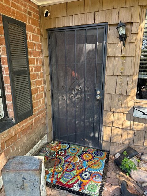 Front door with custom mosaic welcome mat.