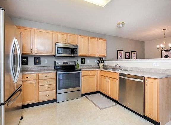 The kitchen boast stainless steel appliances with custom cabinetry.