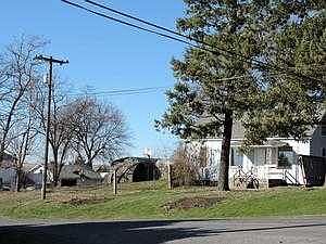 VIEW OF SIDE YARD AND SUBJECT FROM STREET