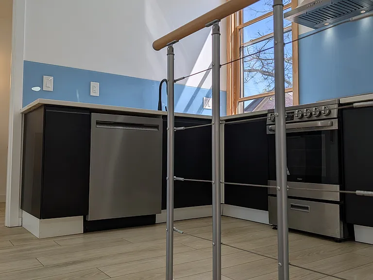 Stairs lead to the landing between the kitchen and living area.