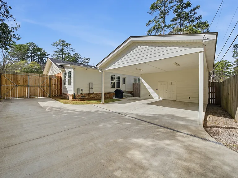 rear view of carport with secure storage room