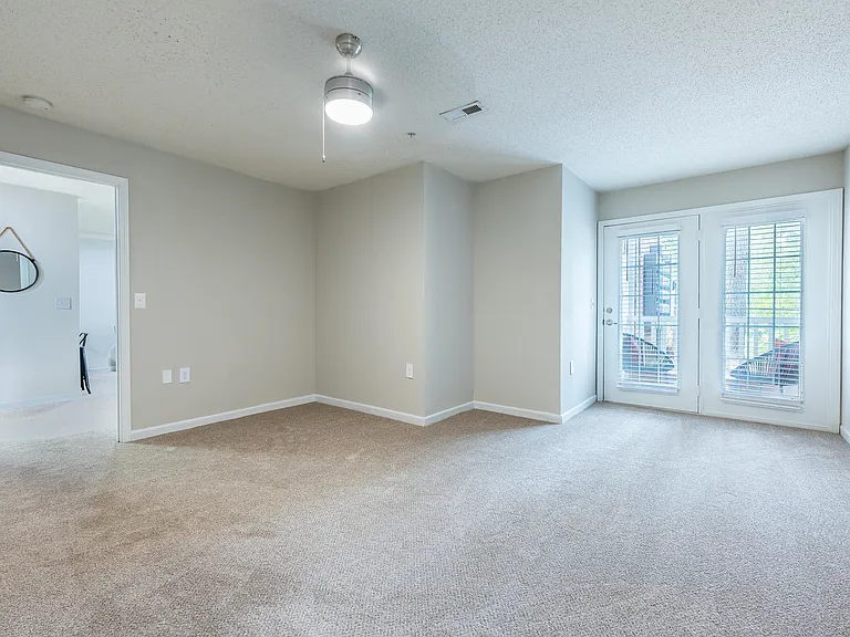 Spacious living room with carpet & overhead lighting