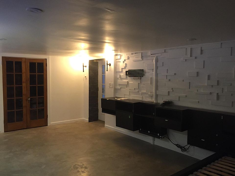 Entry way with walk in utility closet, an built in entertainment shelves with TV mount ready to go!