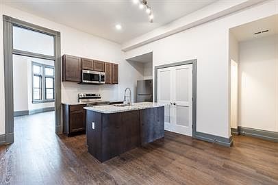 Solid wood cabinets, stainless appliances including dishwasher and microwave, lots of storage.