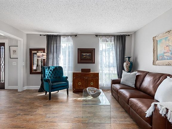 When the evening calls for a bottle of wine OR catching up with friends OR a holiday gathering take advantage of the cozy yet spacious elegance of the formal living. Two large windows frame the space continuing the theme of natural light throughout.