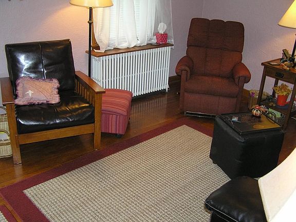 Parkway facing living room with classic coved ceilings