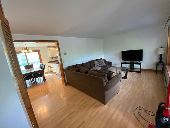 The glass door in the background, past the table, leads into the four-season room.