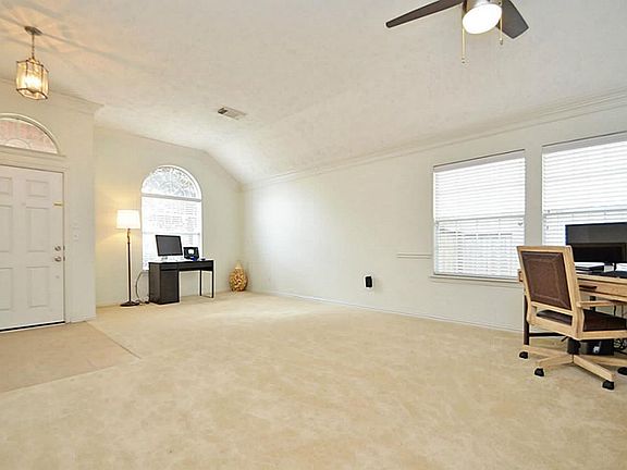 Formal living area offers crown molding.
