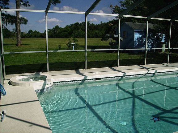Pool overlooking yard and greenbelt