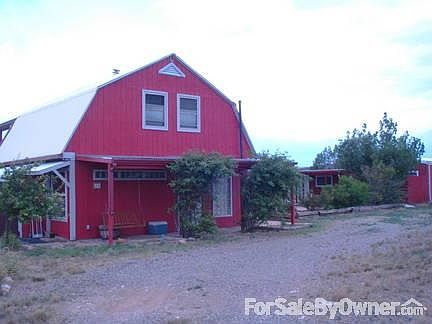 Front view with adjoining guest house
						:
						Hilltop location with 360 view. Fenced acreage for horses and other critters.