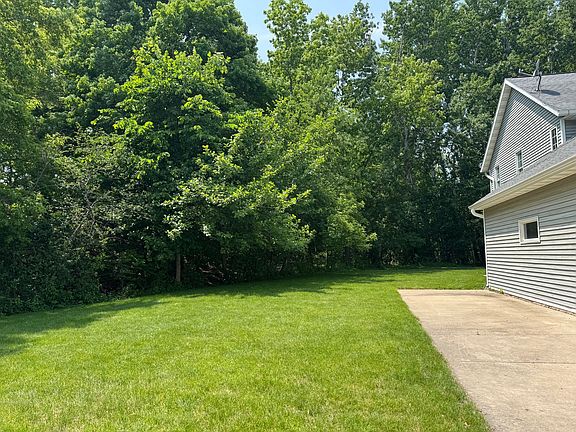 private wooded backyard and extra parking space