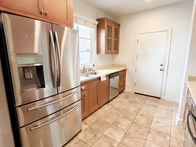 Bright kitchen with stainless steel appliances, ample counter space, and abundant cabinetry
