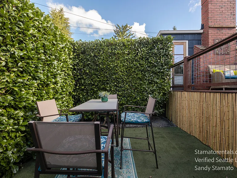 The private lower patio offers another outdoor living space for dining, reading, or enjoying Seattle's mild evenings.