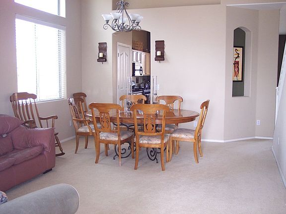 family room with 2-story ceilings and custom nooks opens to the upstairs loft