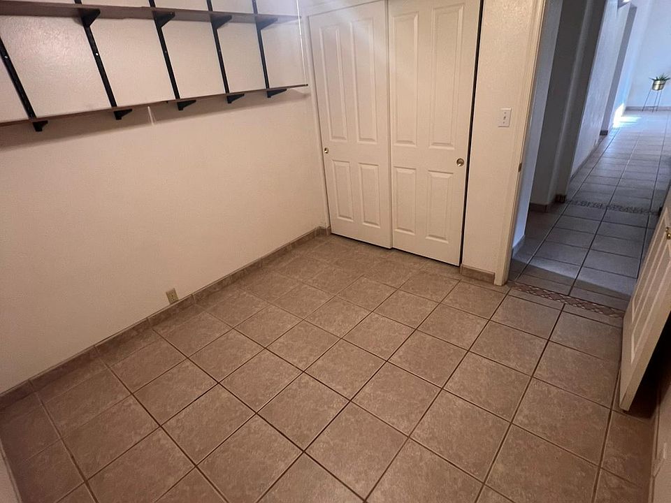 room 2 , ceiling fan , closet and shelves.