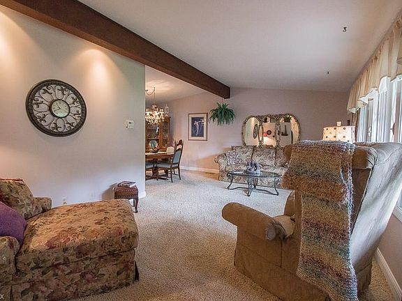 Vaulted ceilings and large windows welcome you into the combined Living Room and Dining Room.