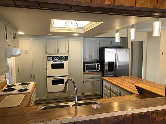 kitchen-two ovens, refrigerator, stove top, dishwasher, two-tub stainless sink, plus plenty of counter and storage