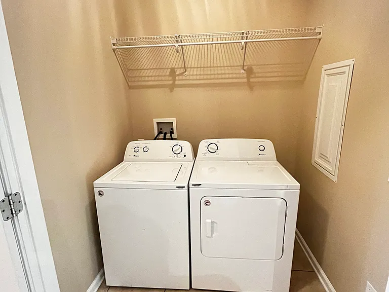 Large laundry room with washer and dryer included.