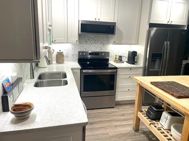 Kitchen details, including stainless steel appliances & terrazzo counters