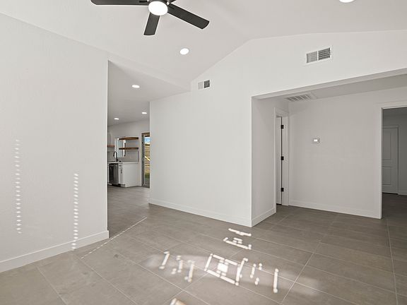 Living room aimed towards kitchen, bathroom, and bedroom