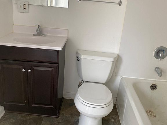 Tub shower area in large bath with ceramic flooring
