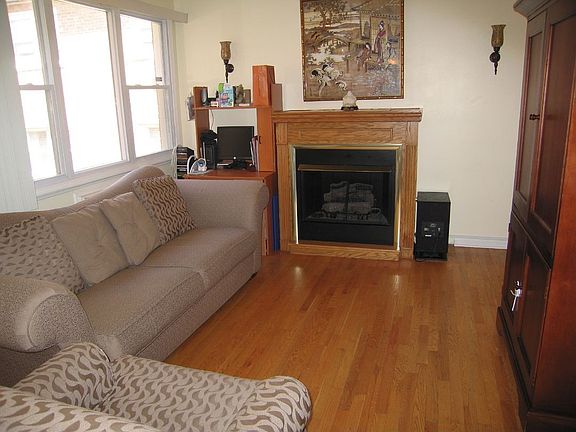 Lovely oak mantle around the cozy fireplace!