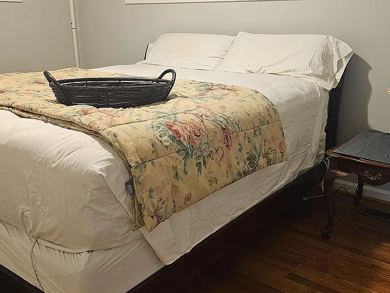 Deluxe California King bed with shared full bathroom