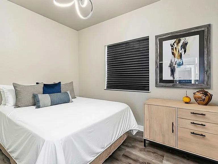 bedroom with queen bed, room darkening shades
