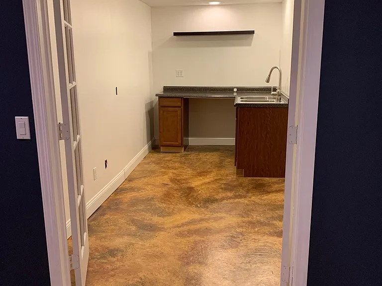 Craft room kitchenette in basement with french doors