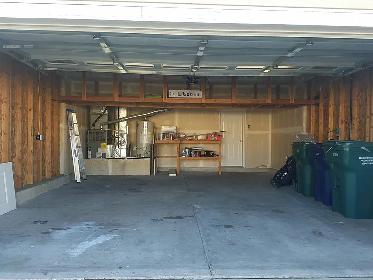 Two car garage with additional hanging storage space.