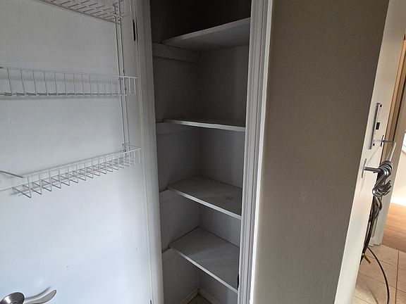 Spacious pantry--can see kitchen color and floor tiles here. W/D hookup in kitchen, also