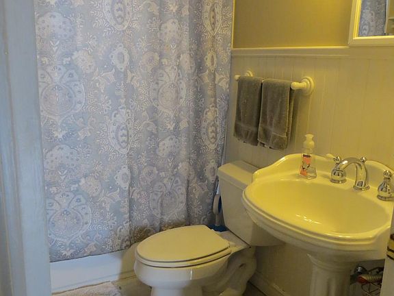 Ceramic tile floor and tub surround, bead board walls, pedes