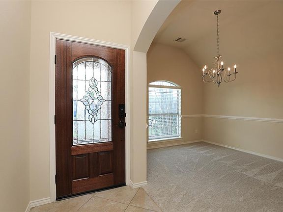 Enter through the leaded glass front door to high ceilings and twenty inch tile on the diagonal.