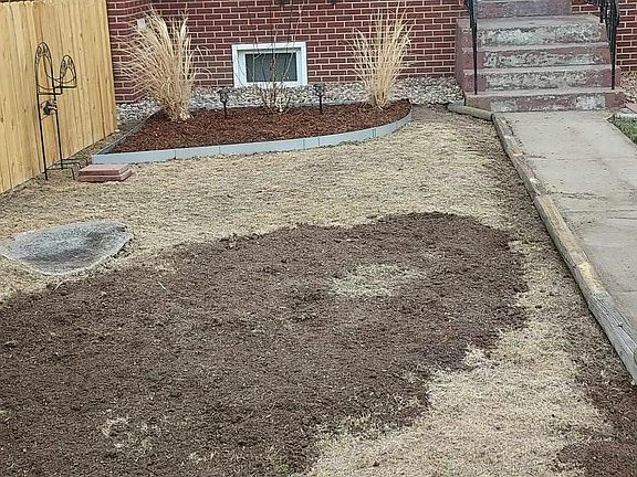 West of sidewalk, re-landscape in progress. Dirt & grass will be river rock