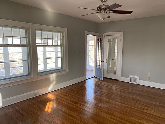 Front door to porch and large closet with mirrored door.