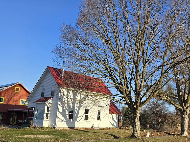 This light filled home sits on a corner lot next to owners home
