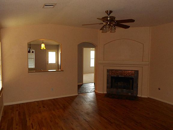 Wood floors and slate surround fireplace greet you as you open the front door